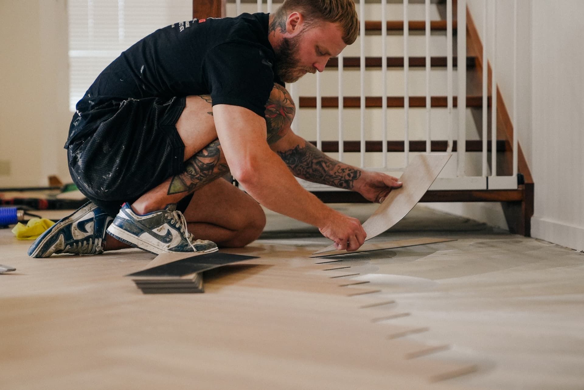 Sutto's installer laying vinyl planks over a prepared floor